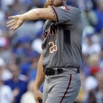 Arizona Diamondbacks relief pitcher Archie Bradley wipes his face after Chicago Cubs' Willson Contreras hit a two-run single during the seventh inning of a baseball game Thursday, Aug. 3, 2017, in Chicago. (AP Photo/Nam Y. Huh)