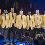 The 2017 Class of the Pro Football Hall of Fame pose during the Enshrinee's Gold Jacket Dinner, Friday, Aug. 4, 2017, in Canton, Ohio. From left to right, are: Kurt Warner, Terrell Davis, Jason Taylor, Jerry Jones, LaDainian Tomlinson, Morten Andersen and Kenny Easley. (Bob Rossiter/The Canton Repository via AP)