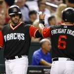 Arizona Diamondbacks' David Peralta (6) celebrates after scoring against the San Francisco Giants, with J.D. Martinez, left, during the third inning of a baseball game Friday, Aug. 25, 2017, in Phoenix. (AP Photo/Ross D. Franklin)