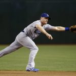 Los Angeles Dodgers' Logan Forsythe is unable to track down a ground ball for a single by Arizona Diamondbacks' David Peralta during the fourth inning of a baseball game Wednesday, Aug. 30, 2017, in Phoenix. (AP Photo/Ross D. Franklin)