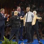 NFL Commissioner Roger Goodell, left, and David Baker, president of the Pro Football Hall of Fame, applaud as Jason Taylor receives his gold jacket from presenter, Jimmy Johnson, at the Pro Football Hall of Fame enshrinees' dinner, Friday, Aug. 4, 2017, in Canton, Ohio. (Bob Rossiter/The Canton Repository via AP)