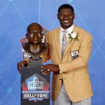 Former NFL player LaDainian Tomlinson poses with a bust of himself during an induction ceremony at the Pro Football Hall of Fame, Saturday, Aug. 5, 2017, in Canton, Ohio. (AP Photo/Gene J. Puskar)