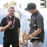 Mick Fanning, left, speaks to the crowd during his induction ceremony into the Surfers' Hall of Fame in Huntington Beach, Calif., Friday, Aug. 4, 2017. (Nick Agro/The Orange County Register via AP)