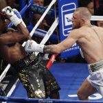 Conor McGregor hits Floyd Mayweather Jr. in a super welterweight boxing match Saturday, Aug. 26, 2017, in Las Vegas. (AP Photo/Eric Jamison)