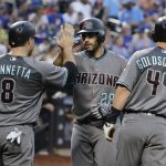 Arizona Diamondbacks' Chris Iannetta (8) and Paul Goldschmidt (44) celebrate with teammate J.D. Martinez after they scored on his three-run home run during the first inning of a baseball game against the New York Mets Tuesday, Aug. 22, 2017, in New York. (AP Photo/Frank Franklin II)