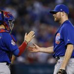 Chicago Cubs' Wade Davis, right, celebrates the final out against the Arizona Diamondbacks with catcher Victor Caratini, left, during the ninth inning of a baseball game Sunday, Aug 13, 2017, in Phoenix. (AP Photo/Ross D. Franklin)