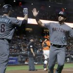Arizona Diamondbacks' David Peralta, right, is congratulated by J.D. Martinez after scoring against the San Francisco Giants during the sixth inning of a baseball game in San Francisco, Friday, Aug. 4, 2017. (AP Photo/Jeff Chiu)