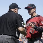 Arizona Diamondbacks manager Torey Lovullo, right, talks with umpire Brian O'Nora (7) during the fifth inning of a baseball game between the San Francisco Giants and the Diamondbacks in San Francisco, Sunday, Aug. 6, 2017. The Giants won 6-3. (AP Photo/Jeff Chiu)