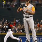 San Francisco Giants' Madison Bumgarner, right, pauses on the mound with a new baseball after giving up a home run against Arizona Diamondbacks' A.J. Pollock, left, during the first inning of a baseball game Saturday, Aug. 26, 2017, in Phoenix. (AP Photo/Ross D. Franklin)