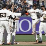 San Francisco Giants center fielder Gorkys Hernandez, second from right, and right fielder Jarrett Parker, right, celebrate with teammates after a baseball game against the Arizona Diamondbacks in San Francisco, Sunday, Aug. 6, 2017. The Giants won 6-3. (AP Photo/Jeff Chiu)