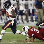 Chicago Bears punt returner Benny Cunningham run as Arizona Cardinals punter Richie Leone (9) and cornerback Brandon Williams (26) reach for the tackle during the first half of a preseason NFL football game, Saturday, Aug. 19, 2017, in Glendale, Ariz. (AP Photo/Ross D. Franklin)