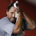 After finishing pitching in the fifth inning, Chicago Cubs' John Lackey wipes his face, having given up a two-run home run to Arizona Diamondbacks' David Peralta, during a baseball game Friday, Aug 11, 2017, in Phoenix. (AP Photo/Ross D. Franklin)