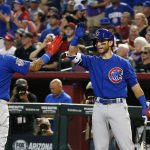 Chicago Cubs' Javier Baez (9) celebrates his run scored against the Arizona Diamondbacks with Tommy La Stella, right, during the second inning of a baseball game Sunday, Aug 13, 2017, in Phoenix. (AP Photo/Ross D. Franklin)