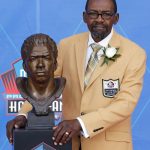 Former NFL player Kenny Easley poses with a bust of himself during an induction ceremony at the Pro Football Hall of Fame, Saturday, Aug. 5, 2017, in Canton, Ohio. (AP Photo/Ron Schwane)