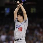Los Angeles Dodgers starting pitcher Kenta Maeda (18) wipes his brow after giving up a home run against the Arizona Diamondbacks during the fifth inning of a baseball game, Tuesday, Aug. 8, 2017, in Phoenix. (AP Photo/Matt York)
