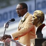 Former NFL player Kenny Easley speaks next a bust of himself during an induction ceremony at the Pro Football Hall of Fame Saturday, Aug. 5, 2017, in Canton, Ohio. (AP Photo/Ron Schwane)