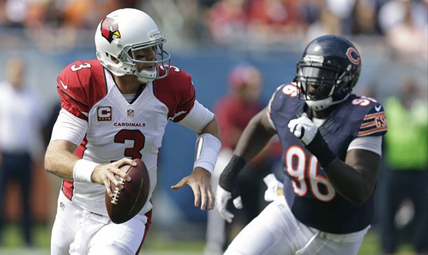 Arizona Cardinals quarterback Carson Palmer (3) scrambles away from Chicago Bears defensive tackle ...