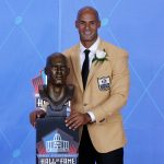 Former NFL player Jason Taylor poses with a bust of himself during an induction ceremony at the Pro Football Hall of Fame, Saturday, Aug. 5, 2017, in Canton, Ohio. (AP Photo/Gene J. Puskar)