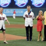 Former Minnesota Twin Rod Carew, right, and his wife, Rhonda, watch along with Ralph Reuland after his wife, Mary, left, threw out a ceremonial first pitch, part of donor day, before the Twins' baseball game against the Arizona Diamondbacks on Friday, Aug. 18, 2017, in Minneapolis. Carew received a new heart and kidney from the Reulands' late son Konrad, a former NFL player. (AP Photo/Jim Mone)