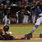 Arizona Diamondbacks' David Peralta, left, slides across home plate ahead of the tag by Chicago Cubs catcher Alex Avila as he scores on an inside-the-park home run during the eighth inning of a baseball game, Saturday, Aug. 12, 2017, in Phoenix. (AP Photo/Ralph Freso)