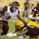 New Mexico State running back Larry Rose III (3) stiff-arms Arizona State defensive back J'Marcus Rhodes (17) during the first half during an NCAA college football game, Thursday, Aug. 31, 2017, in Tempe, Ariz. (AP Photo/Rick Scuteri)