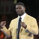 Tears run down the face of LaDainian Tomlinson as he reacts to the crowd after receiving his gold jacket during the Pro Football Hall of Fame Festival Enshrinees' Gold Jacket Dinner at the Canton Memorial Civic Center in Canton, Ohio, Friday, Aug. 4, 2017. (Scott Heckel/The Canton Repository via AP)