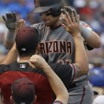 Arizona Diamondbacks' Brandon Drury, top, celebrates with teammates after hitting a solo home run against the Chicago Cubs during the first inning of a baseball game Thursday, Aug. 3, 2017, in Chicago. (AP Photo/Nam Y. Huh)
