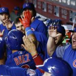 Chicago Cubs' Javier Baez, second from left, celebrates his three-run home run against the Arizona Diamondbacks with Victor Caratini (20), assistant hitting coach Eric Hinske, right, and other teammates during the eighth inning of a baseball game Sunday, Aug 13, 2017, in Phoenix.  (AP Photo/Ross D. Franklin)