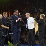 NFL Commissioner Roger Goodell, left, and David Baker, president of the Pro Football Hall of Fame, applaud as Morten Andersen receives his gold jacket from his son and presenter, Sebastian Andersen, at the Pro Football Hall of Fame enshrinees' dinner, Friday, Aug. 4, 2017, in Canton, Ohio. (Bob Rossiter/The Canton Repository via AP)