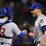 Chicago Cubs' Mike Montgomery, right, celebrates with catcher Alex Avila (13) after the final out of the team's baseball game against the Arizona Diamondbacks on Friday, Aug 11, 2017, in Phoenix. The Cubs defeated the Diamondbacks 8-3. (AP Photo/Ross D. Franklin)