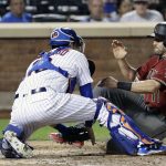 New York Mets catcher Travis d'Arnaud, left, tags out Arizona Diamondbacks' A.J. Pollock, right, during the fifth inning of a baseball game Wednesday, Aug. 23, 2017, in New York. (AP Photo/Frank Franklin II)