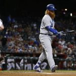 Los Angeles Dodgers' Justin Turner, right, walks back to the dugout after striking out as Arizona Diamondbacks' Chris Herrmann (10) runs off the field during the first inning of a baseball game Wednesday, Aug. 30, 2017, in Phoenix. (AP Photo/Ross D. Franklin)