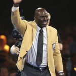 Terrell Davis waves to the crowd after receiving his gold jacket during the Pro Football Hall of Fame dinner at Canton Memorial Civic Center in Canton, Ohio, Friday, Aug. 4, 2017. (Scott Heckel/The Canton Repository via AP)