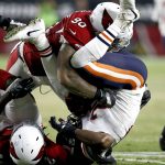 Chicago Bears running back Benny Cunningham is up-ended by Arizona Cardinals defensive tackle Robert Nkemdiche (90) during the first half of a preseason NFL football game, Saturday, Aug. 19, 2017, in Glendale, Ariz. (AP Photo/Ross D. Franklin)