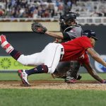 Minnesota Twins' Byron Buxton, right, beats the tag by Arizona Diamondbacks catcher Chris Iannetta to score on an inside-the-park home run off Zack Godley during the fourth inning of a baseball game Friday, Aug. 18, 2017, in Minneapolis. (AP Photo/Jim Mone)