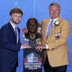 Former NFL player Morten Andersen, right, poses with a bust of himself and presenter and son Sebastian Andersen during an induction ceremony at the Pro Football Hall of Fame, Saturday, August 5, 2017 in Canton, Ohio. (AP Photo/Gene J. Puskar)