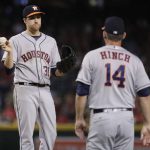 Houston Astros starting pitcher Collin McHugh (31) is pulled from the game by manager A.J. Hinch (14) during the sixth inning of a baseball game against the Arizona Diamondbacks, Monday, Aug. 14, 2017, in Phoenix. (AP Photo/Matt York)