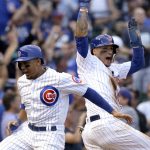 Chicago Cubs' Jon Jay, left, and Javier Baez celebrate after scoring on a single by Willson Contreras during the seventh inning of a baseball game against the Arizona Diamondbacks, Thursday, Aug. 3, 2017, in Chicago. (AP Photo/Nam Y. Huh)
