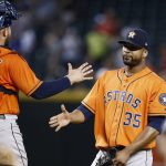 Houston Astros' Francisco Liriano (35) slaps hands with catcher Max Stassi, left, after the final out in the ninth inning of a baseball game against the Arizona Diamondbacks Tuesday, Aug. 15, 2017, in Phoenix. The Astros defeated the Diamondbacks 9-4. (AP Photo/Ross D. Franklin)