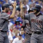 Arizona Diamondbacks' Paul Goldschmidt, right, celebrates with Adam Rosales after hitting a three-run home run during the first inning of a baseball game against the Chicago Cubs, Thursday, Aug. 3, 2017, in Chicago. (AP Photo/Nam Y. Huh)