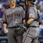 Arizona Diamondbacks starting pitcher Zack Greinke, left, talks with catcher Jeff Mathis during the first inning of a baseball game against the Chicago Cubs, Thursday, Aug. 3, 2017, in Chicago. (AP Photo/Nam Y. Huh)