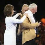 Gene Jones helps her husband, Jerry Jones, with his gold jacket during the Pro Football Hall of Fame dinner at Canton Memorial Civic Center in Canton, Ohio, Friday, Aug. 4, 2017. (Scott Heckel/The Canton Repository via AP)