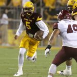 Arizona State quarterback Manny Wilkins (5) runs the ball for a first down against New Mexico State during the first half during an NCAA college football game, Thursday, Aug. 31, 2017, in Tempe, Ariz. (AP Photo/Rick Scuteri)