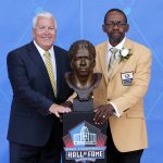 Former NFL player Kenny Easley, right, poses with his bust and his presenter and high school coach, Tommy Rhodes, during his induction at the Pro Football Hall of Fame, Saturday, Aug. 5, 2017, in Canton, Ohio. (AP Photo/Gene J. Puskar)