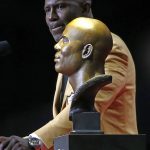 Former NFL player Terrell Davis speaks near a bust of himself during an induction ceremony at the Pro Football Hall of Fame, Saturday, Aug. 5, 2017, in Canton, Ohio. (AP Photo/Ron Schwane)