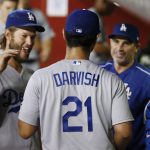 Los Angeles Dodgers' Yu Darvish (21) is congratulated by pitcher Clayton Kershaw, left, hitting coach Turner Ward, second from right, and catcher Austin Barnes (15) after the fifth inning of the team's baseball game against the Arizona Diamondbacks Thursday, Aug 10, 2017, in Phoenix. The Dodgers defeated the Diamondbacks 8-6. (AP Photo/Ross D. Franklin)