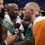 Floyd Mayweather Jr., left, embraces Conor McGregor after a super welterweight boxing match Saturday, Aug. 26, 2017, in Las Vegas. (AP Photo/Isaac Brekken)