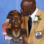 Terrell Davis kisses a bust of him during inductions at the Pro Football Hall of Fame on Saturday, Aug. 5, 2017, in Canton, Ohio. (AP Photo/Gene J. Puskar)