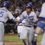 Los Angeles Dodgers' Justin Turner celebrates with Cody Bellinger (35) after hitting a solo home run against the Arizona Diamondbacks during the sixth inning of a baseball game, Tuesday, Aug. 8, 2017, in Phoenix. (AP Photo/Matt York)