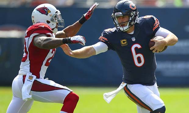 Chicago Bears quarterback Jay Cutler stiff arms Arizona Cardinals strong safety Deone Bucannon duri...